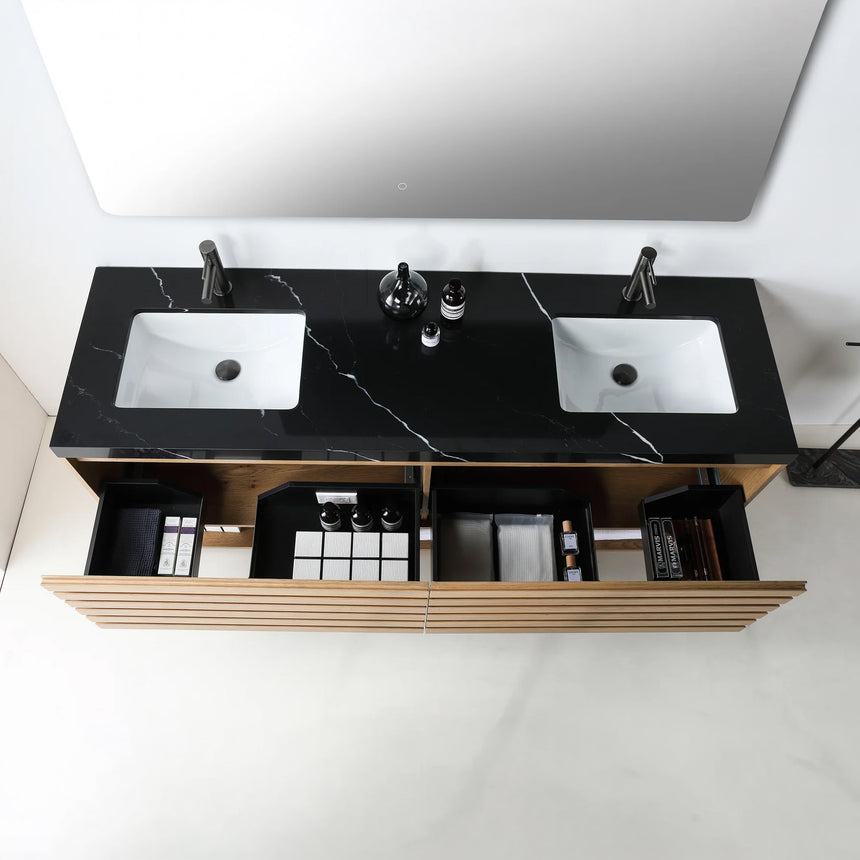A modern floating bathroom vanity with a light oak wood finish, a white countertop, and an integrated sink, shown in a styled bathroom setting with a bathtub, shower glass, and decorative plants.
