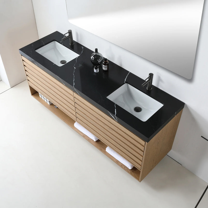 A modern floating bathroom vanity with a light oak wood finish, a white countertop, and an integrated sink, shown in a styled bathroom setting with a bathtub, shower glass, and decorative plants.