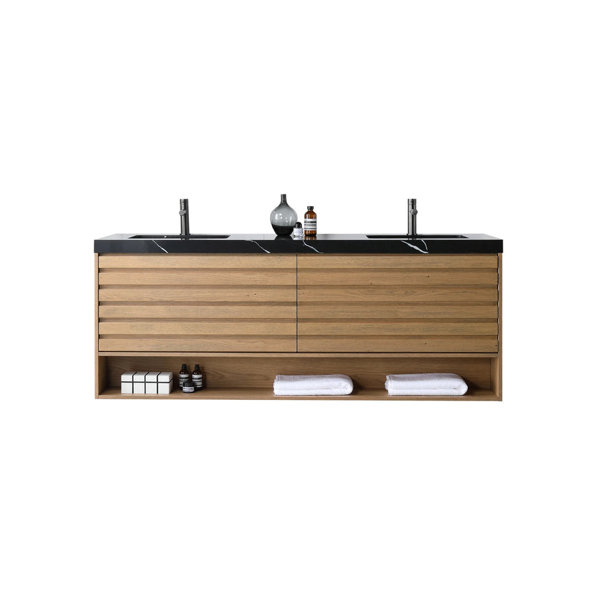 A modern floating bathroom vanity with a light oak wood finish, a white countertop, and an integrated sink, shown in a styled bathroom setting with a bathtub, shower glass, and decorative plants.
