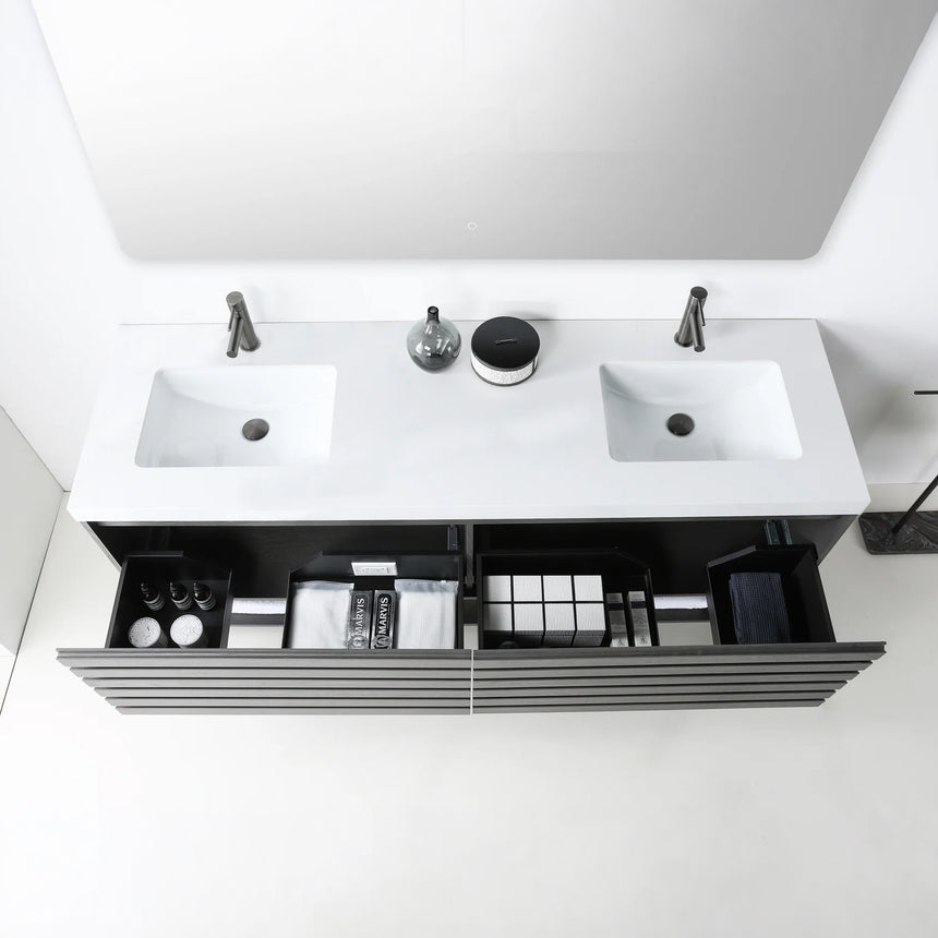 A modern floating bathroom vanity with a light oak wood finish, a white countertop, and an integrated sink, shown in a styled bathroom setting with a bathtub, shower glass, and decorative plants.