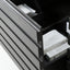 Close-up of a dark gray slatted drawer front with an open drawer revealing white folded items inside.