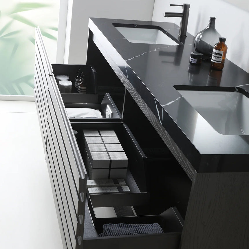 A modern floating bathroom vanity with a light oak wood finish, a white countertop, and an integrated sink, shown in a styled bathroom setting with a bathtub, shower glass, and decorative plants.