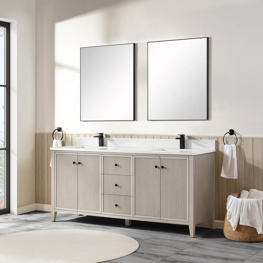 Bathroom vanity with double sink, mirrors, and towels in a well-lit room.