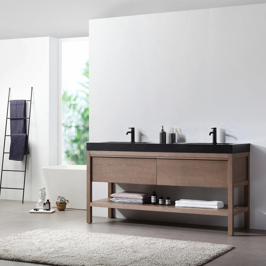 Bathroom vanity with black countertop and wooden cabinet in a bright room.