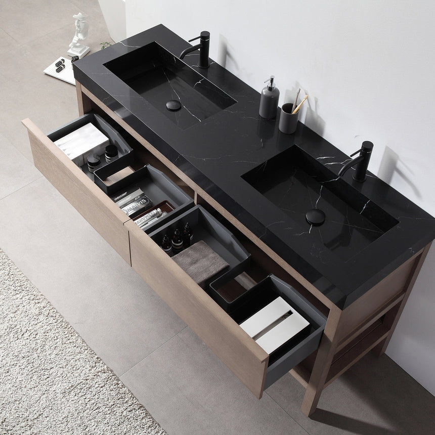Bathroom vanity with black countertop and wooden cabinet in a bright room.