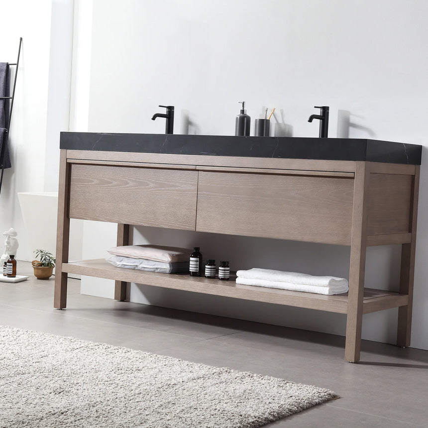 Bathroom vanity with black countertop and wooden cabinet in a bright room.