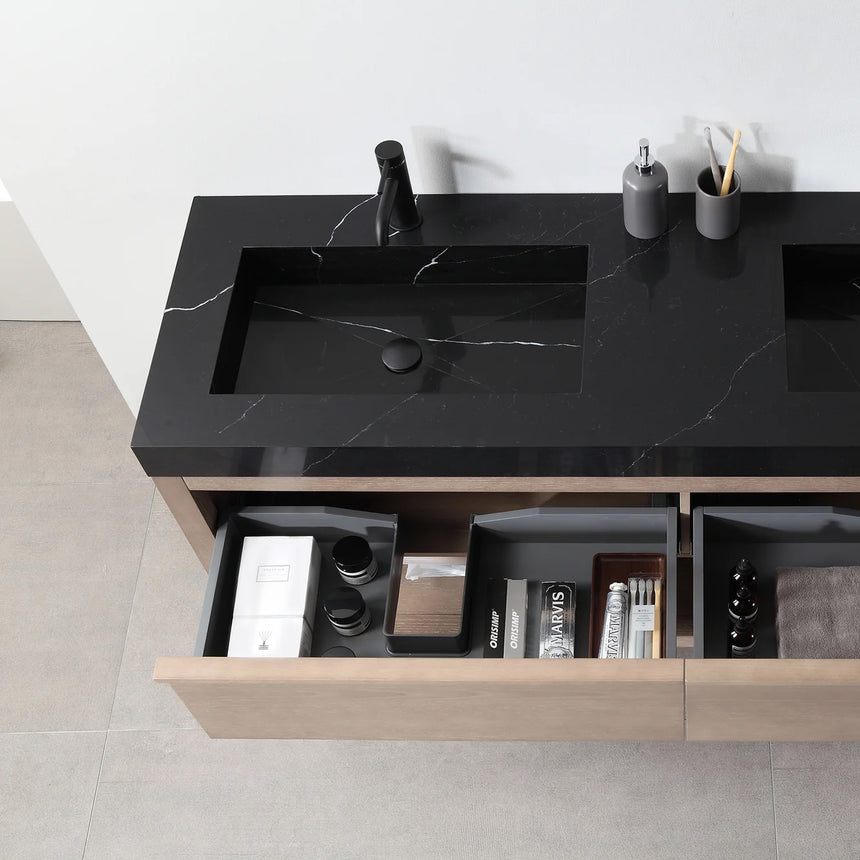 Bathroom vanity with black countertop and wooden cabinet in a bright room.
