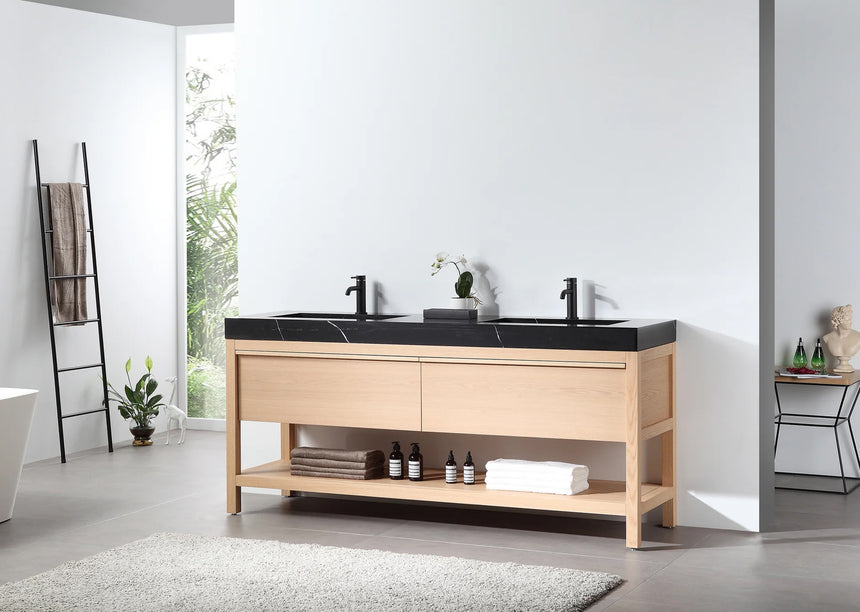 Bathroom vanity with black countertop and wooden cabinet in a bright room.