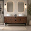 Bathroom vanity with wooden cabinet, two mirrors, and decorative items.