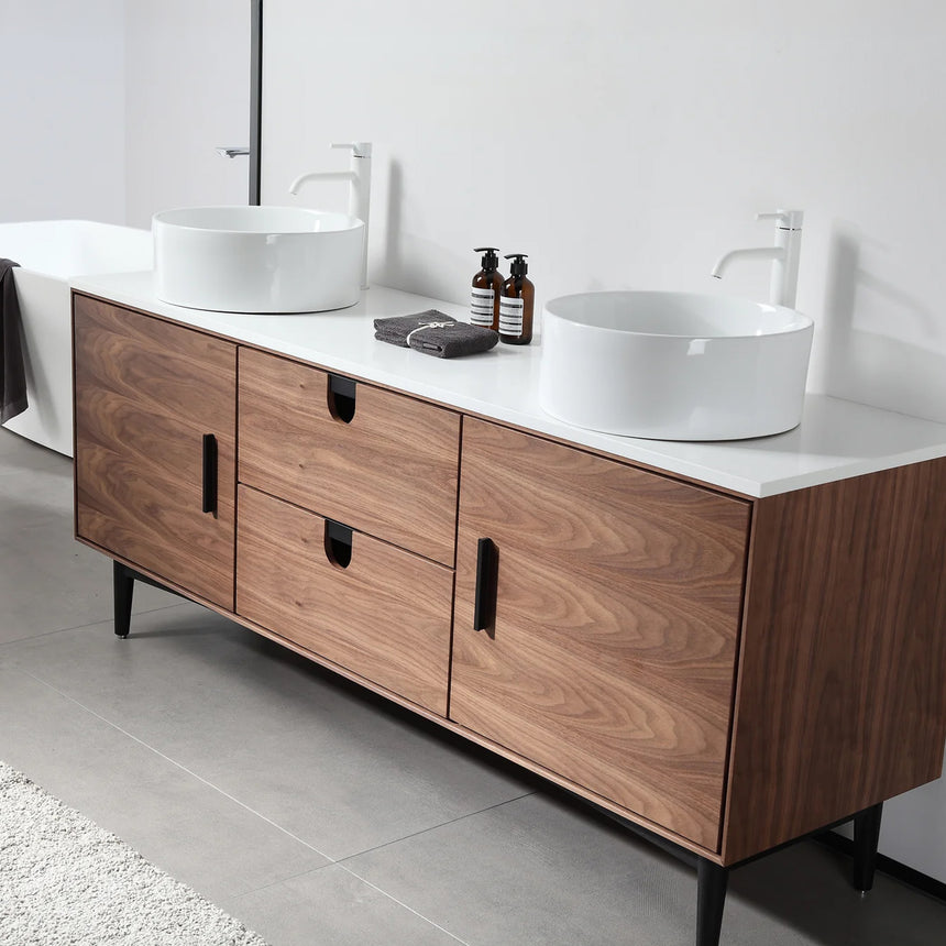 Bathroom vanity with two sinks, mirrors, and decorative elements.