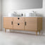 Wooden bathroom vanity with two sinks and a large mirror above it.