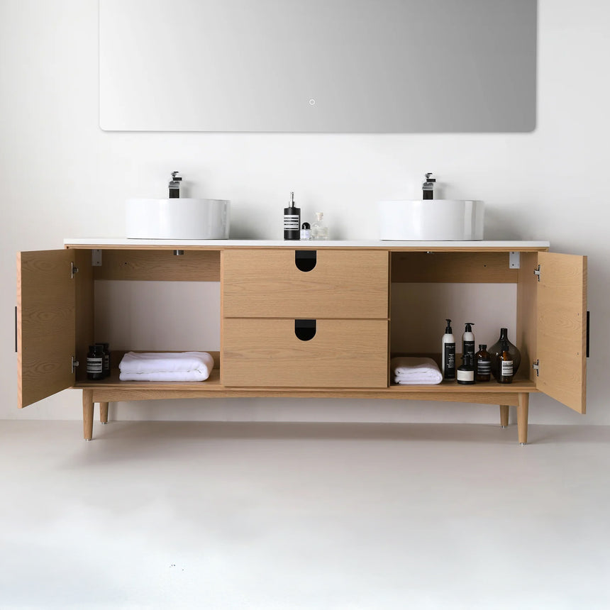 Bathroom vanity with two sinks, mirrors, and decorative elements.