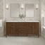 Bathroom vanity with two mirrors, lights, and a sink.