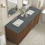 Bathroom vanity with double sink, dark marble countertop, and wooden cabinets.