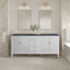 Bathroom vanity with two mirrors, lights, and a bathtub.