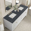 Bathroom vanity with two sinks, dark countertop, and decorative elements.