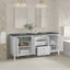 Bathroom vanity with open doors displaying towels and decor, against a tiled wall.