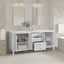 Bathroom vanity with open doors displaying towels and decor, set against a tiled wall.