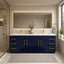Bathroom with a blue vanity, gold fixtures, and a large mirror.