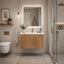 Modern bathroom with wooden vanity, mirror, and shower area.