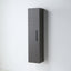 A tall, narrow wall-mounted cabinet with a dark gray wood grain finish and a slim vertical handle, shown against a plain light gray wall.