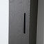 Close-up of a dark gray wood-grain cabinet door with a slim vertical black handle, set against a light gray wall.