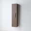 A tall, narrow wall-mounted cabinet in a medium brown wood finish with a slim black vertical handle, shown against a plain white wall.