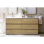 Bathroom vanity with wooden cabinets, white countertop, and gold fixtures.