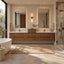 A modern bathroom vanity setup in a bright, contemporary bathroom. The focal point is a floating double-sink vanity with warm wood-grain drawers and cabinets, flanked by two large rectangular backlit mirrors.