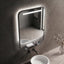 Bathroom setting with a illuminated mirror and sink.