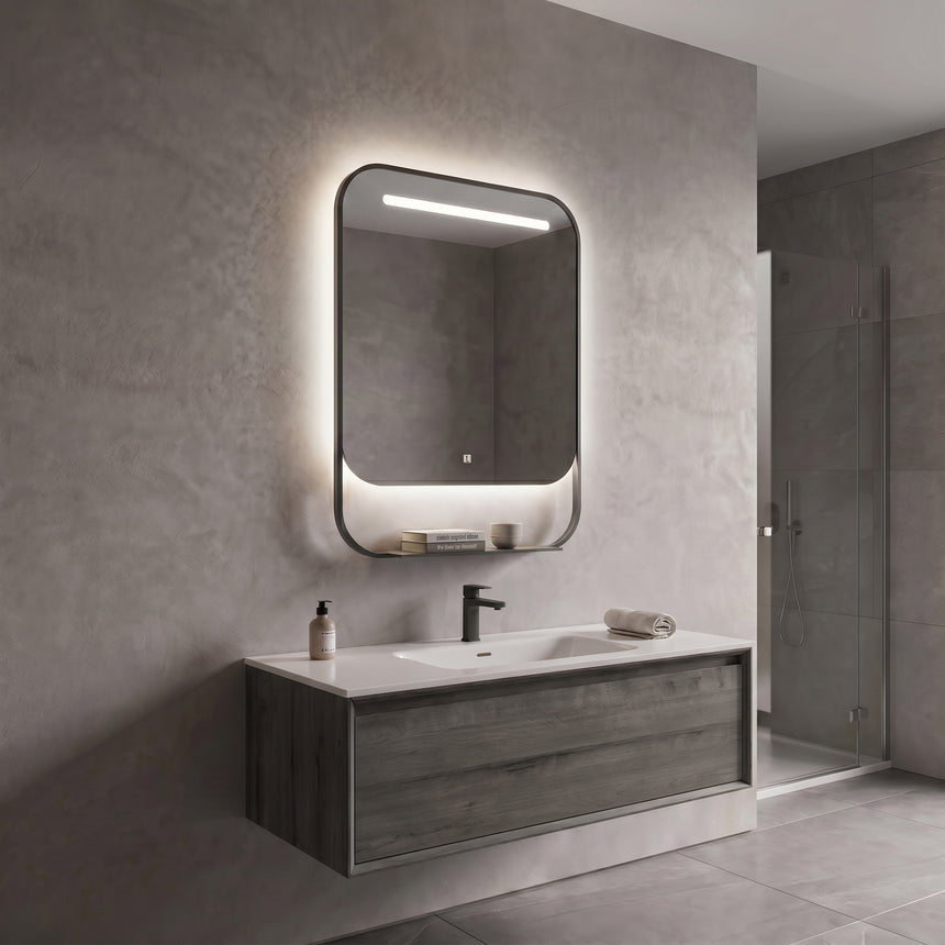 Bathroom mirror with LED lighting on a concrete wall.