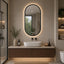 Japandi Modern Bathroom with Oval LED Bathroom Mirror and Floating Vanity.