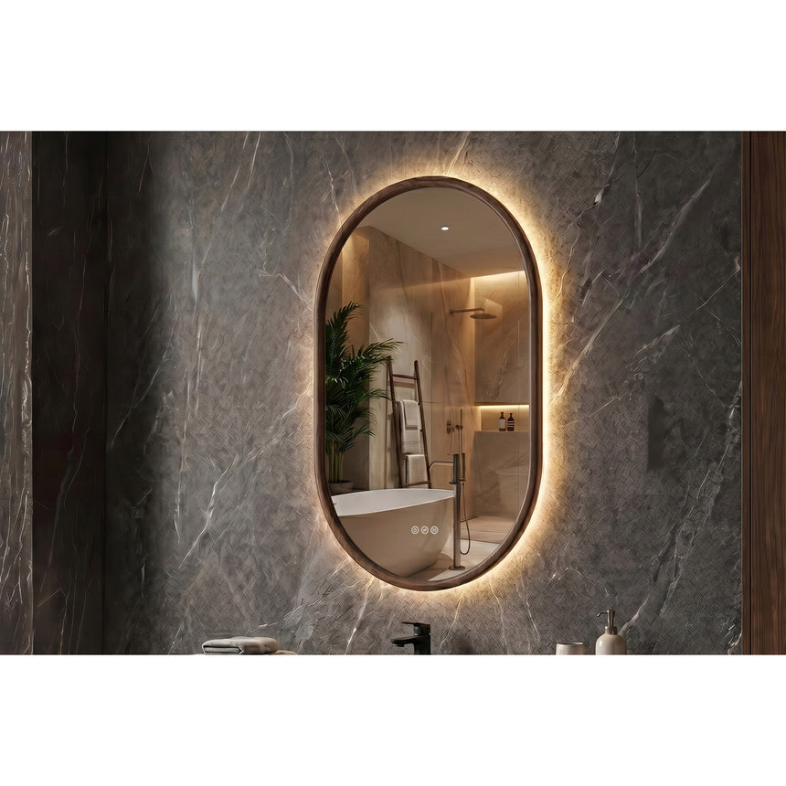 Bathroom mirror with LED lighting on a concrete wall.
